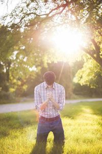 Man kneeling and praying to God.